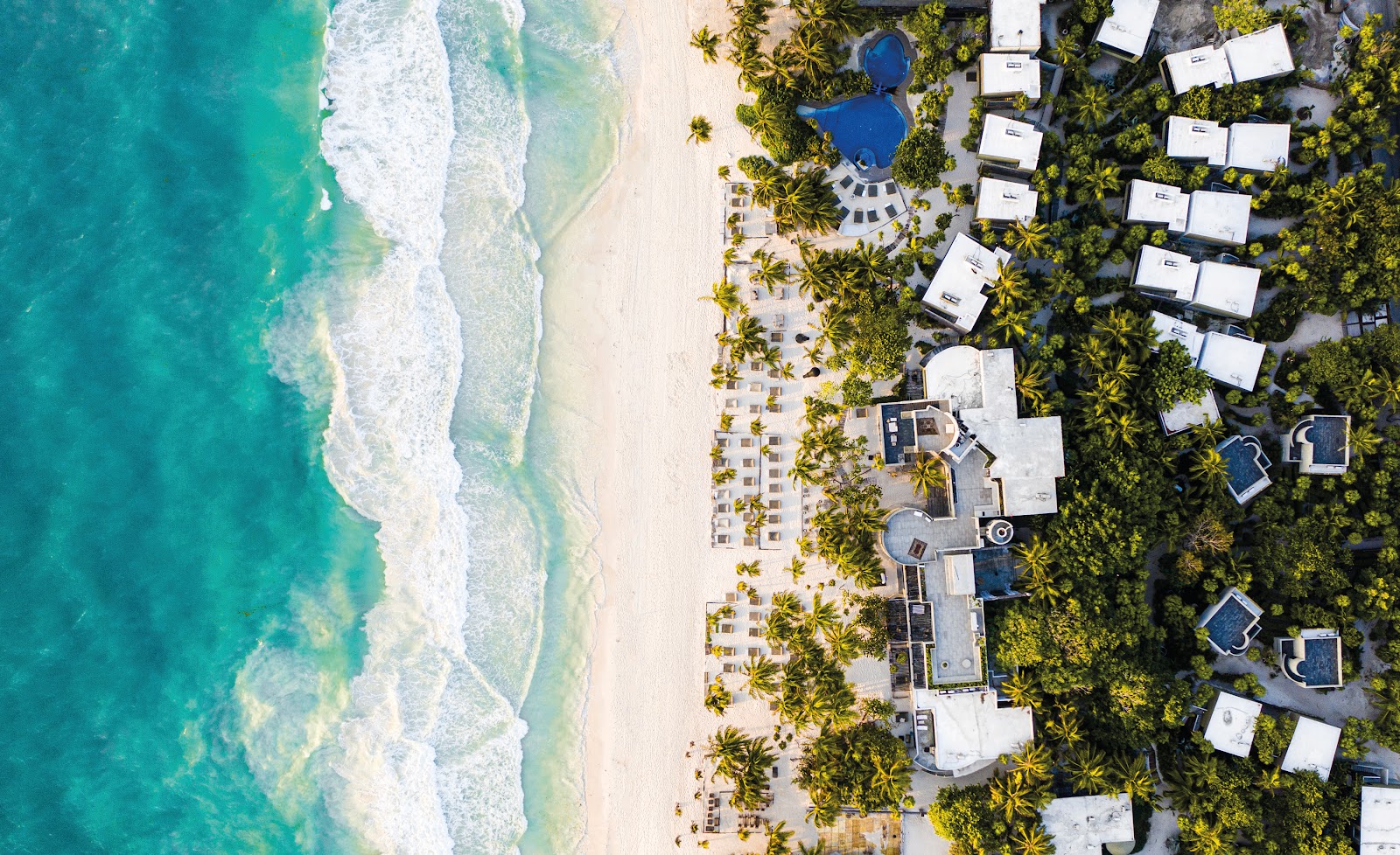 Aerial view of the turquoise sea and white sand beach