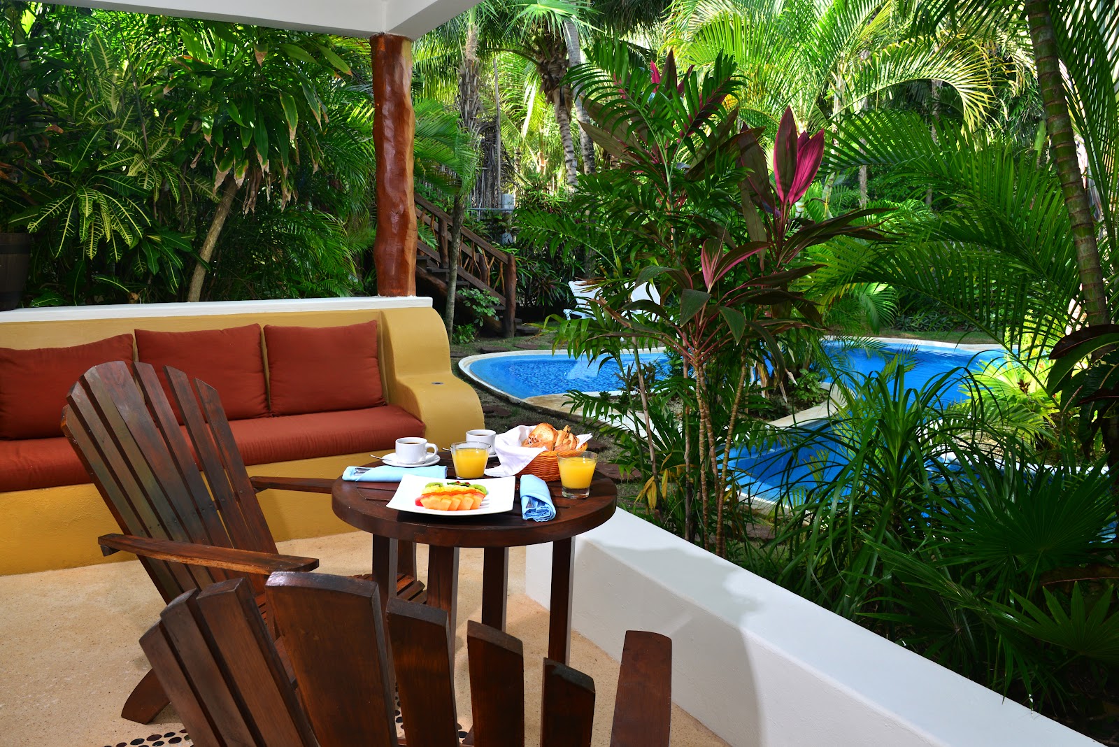 Poolside terrace with lounge chairs at Ana y José Beach Club