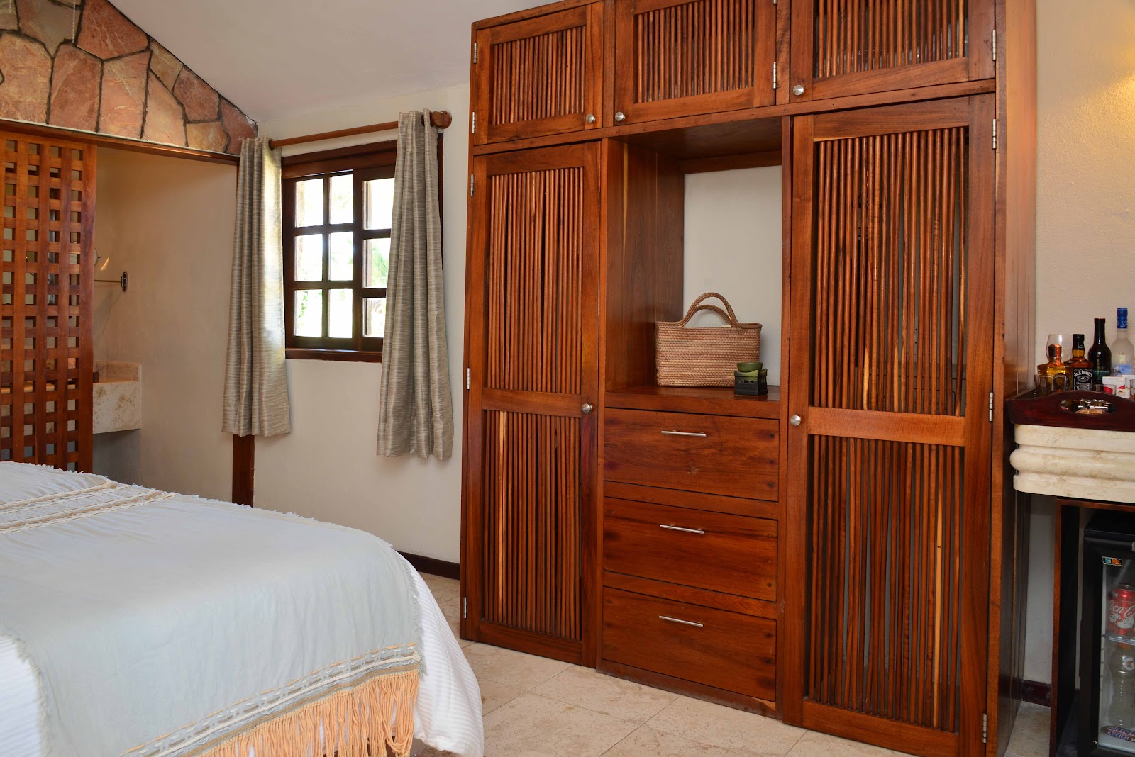 Ana y José Beach Club guest room with carved wooden wardrobe