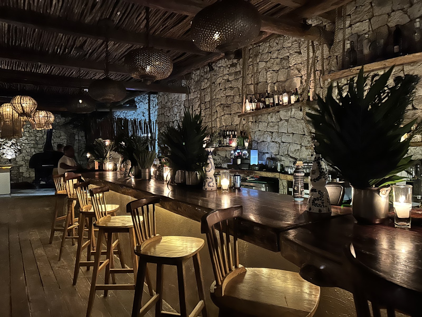 Bar area with high stools and tropical plants