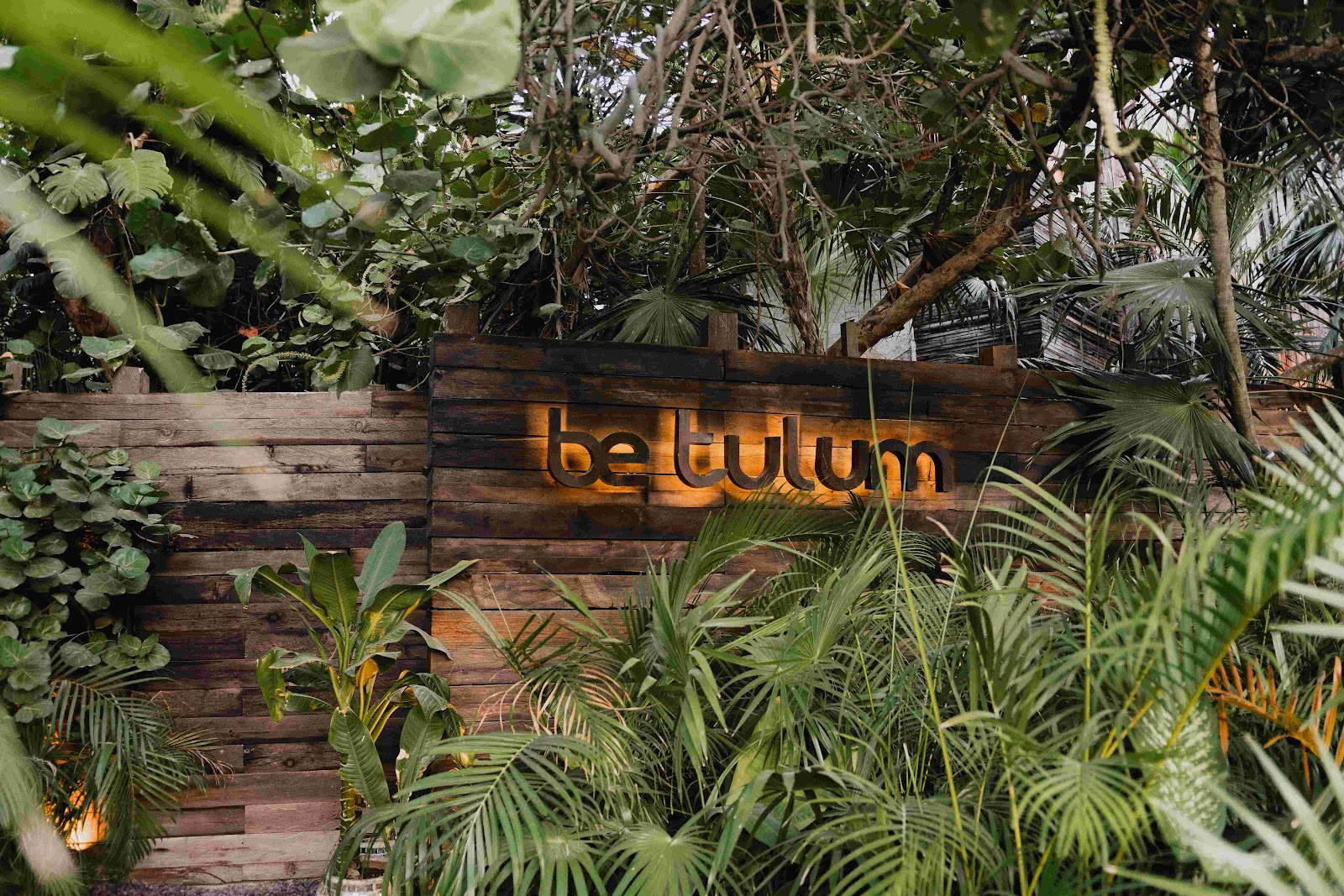 Be Tulum sign surrounded by jungle plants
