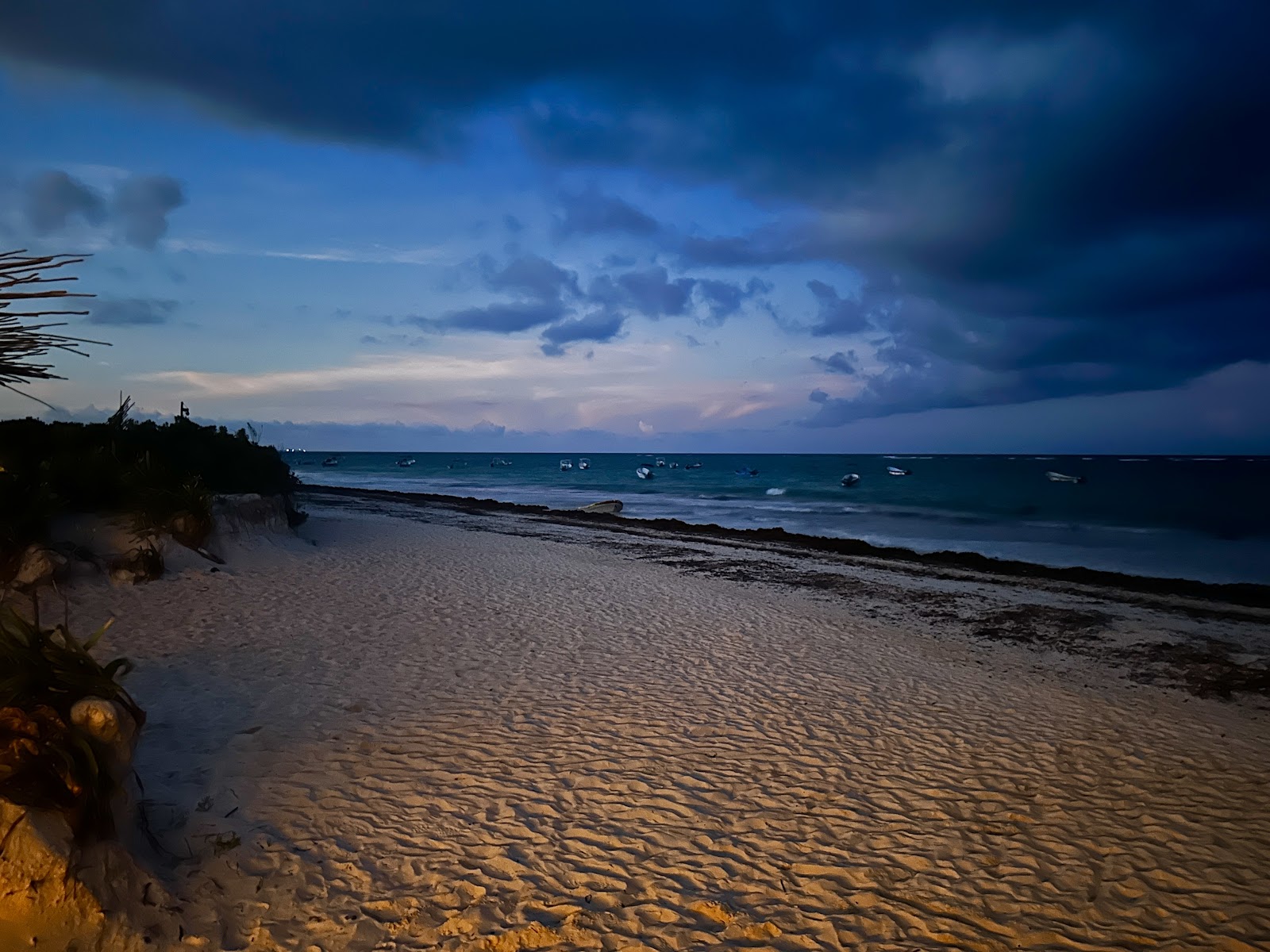 Beach at dusk under a deep blue sky