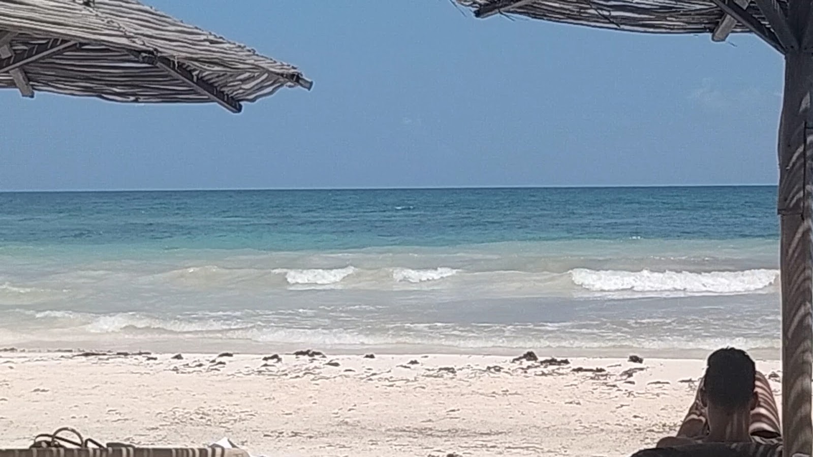 Beach with gentle waves on a cloudy day