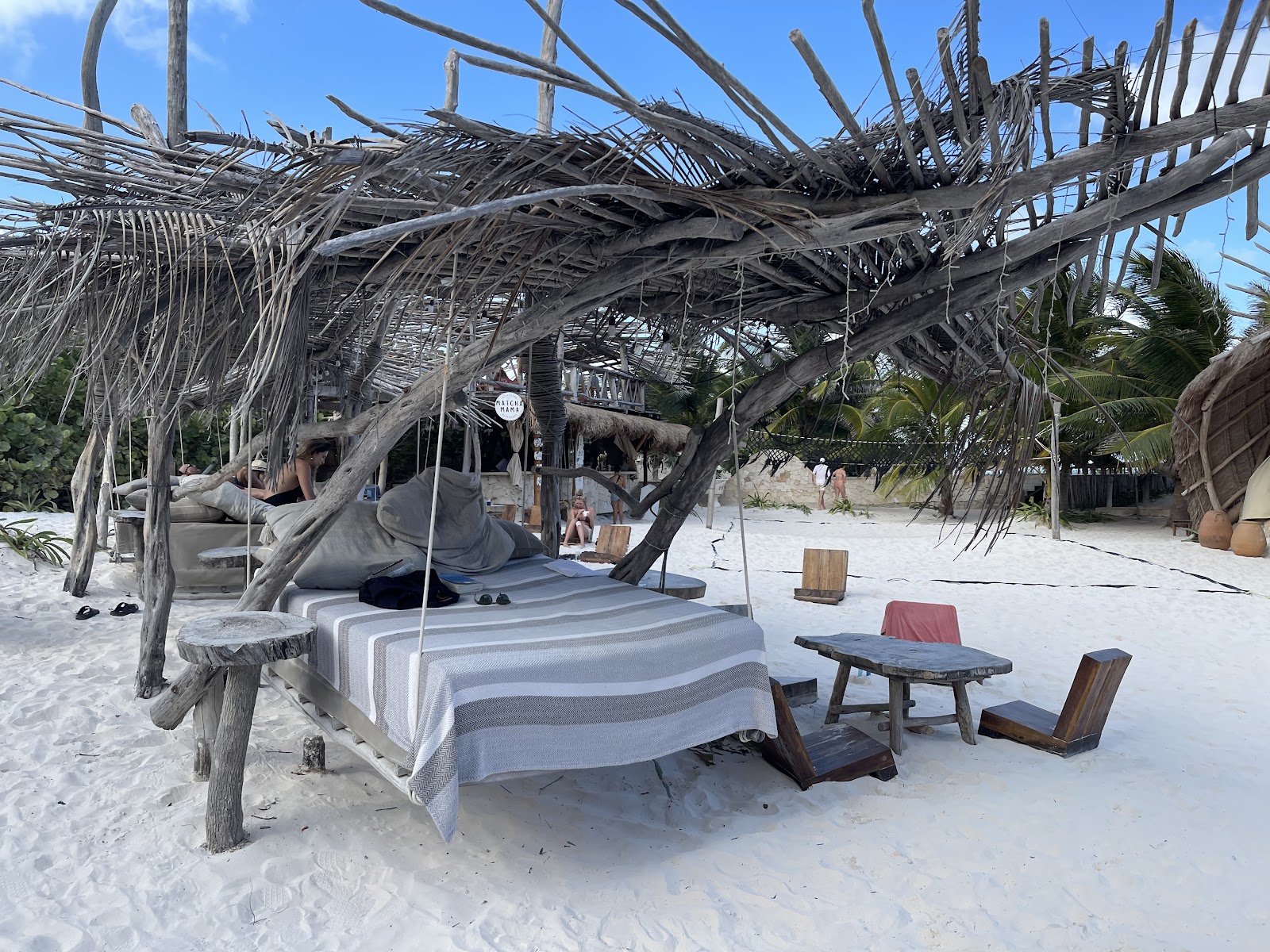 Beach lounge with woven parasols and daybeds