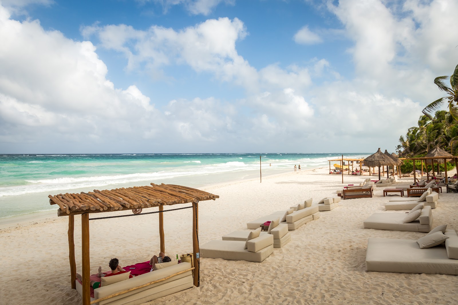Beach setup with a wooden pergola for events