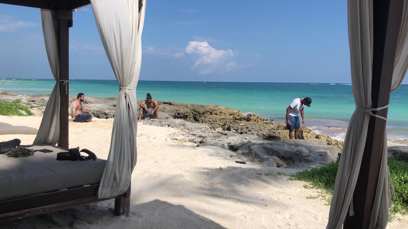Beach view through white curtains