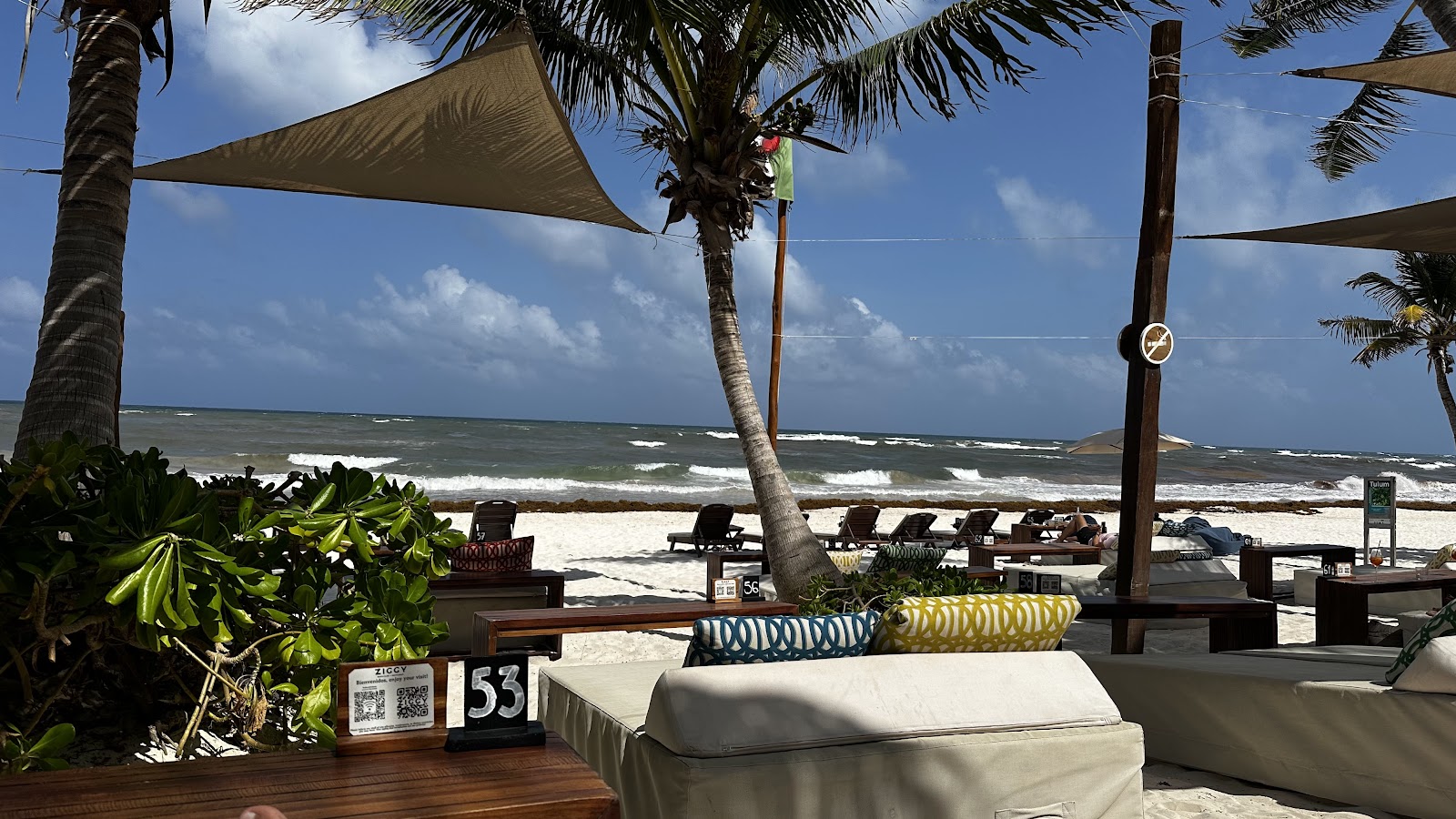 Beachfront lounge area shaded by sails