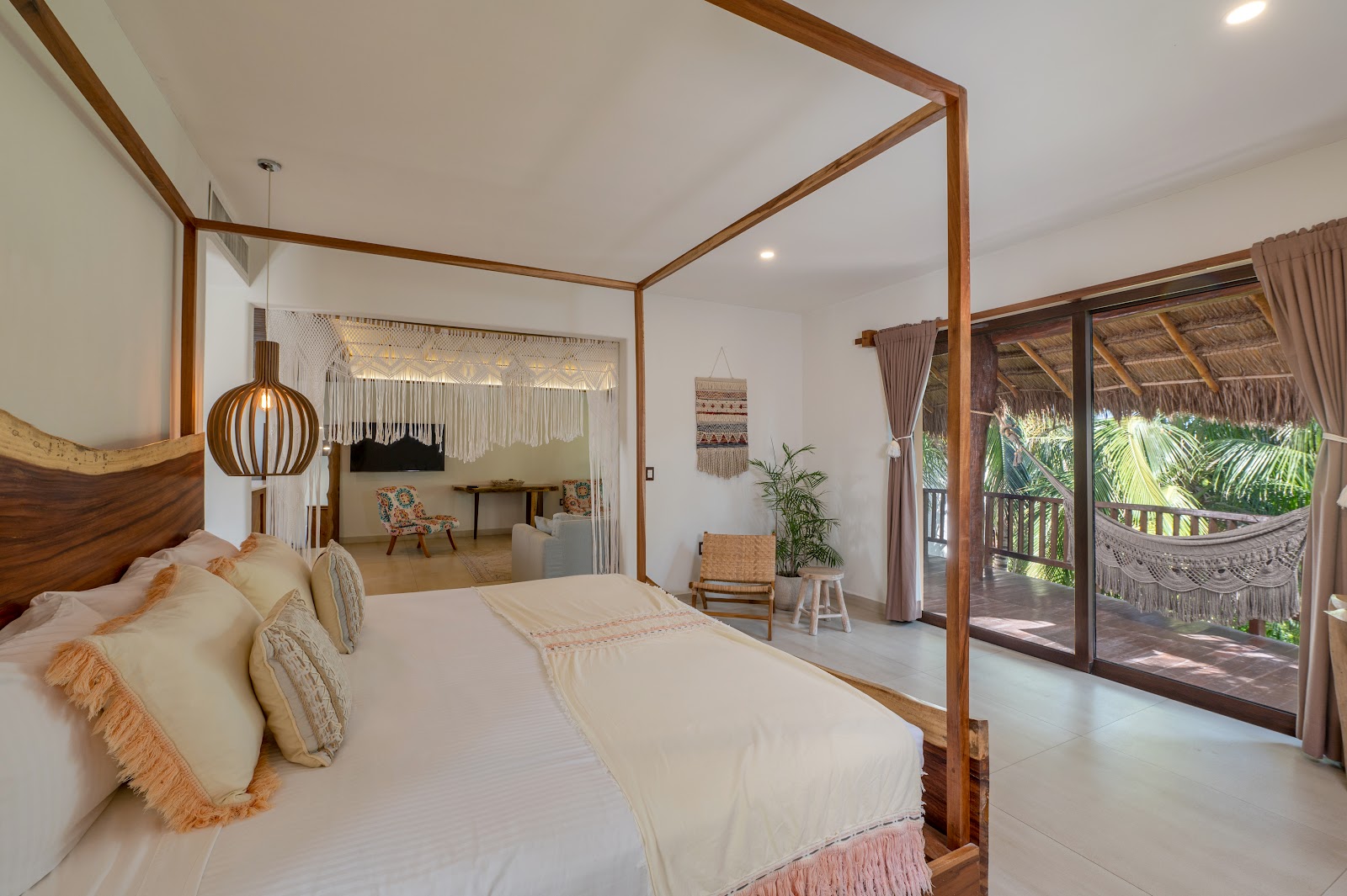 Bright bedroom with four-poster bed and garden-facing windows