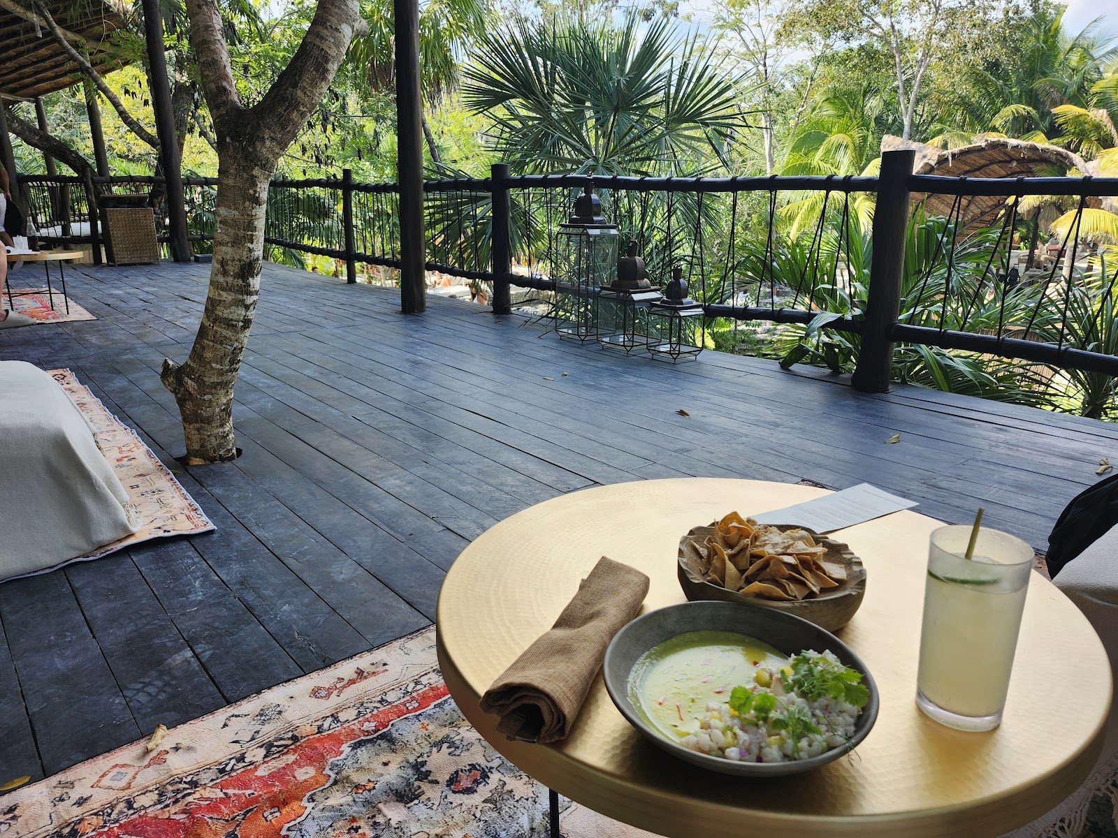 Brunch served on a wooden deck by the jungle
