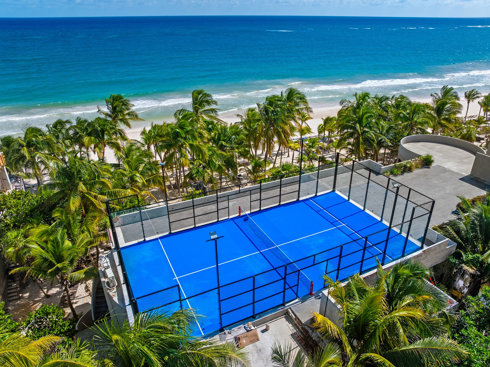 Padel court at Casa Malca surrounded by palm trees