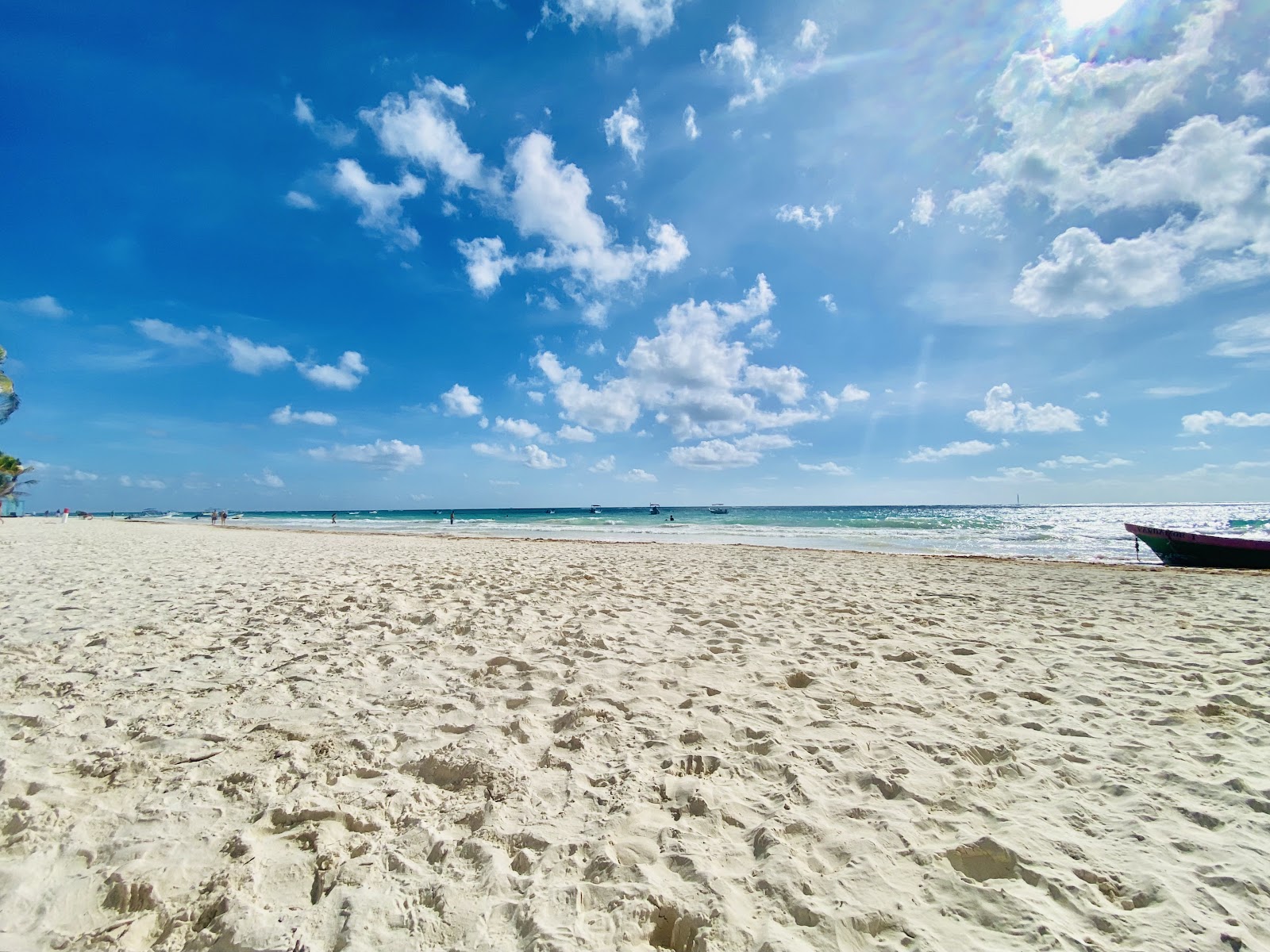 Clean white sand under a clear blue sky in Tulum