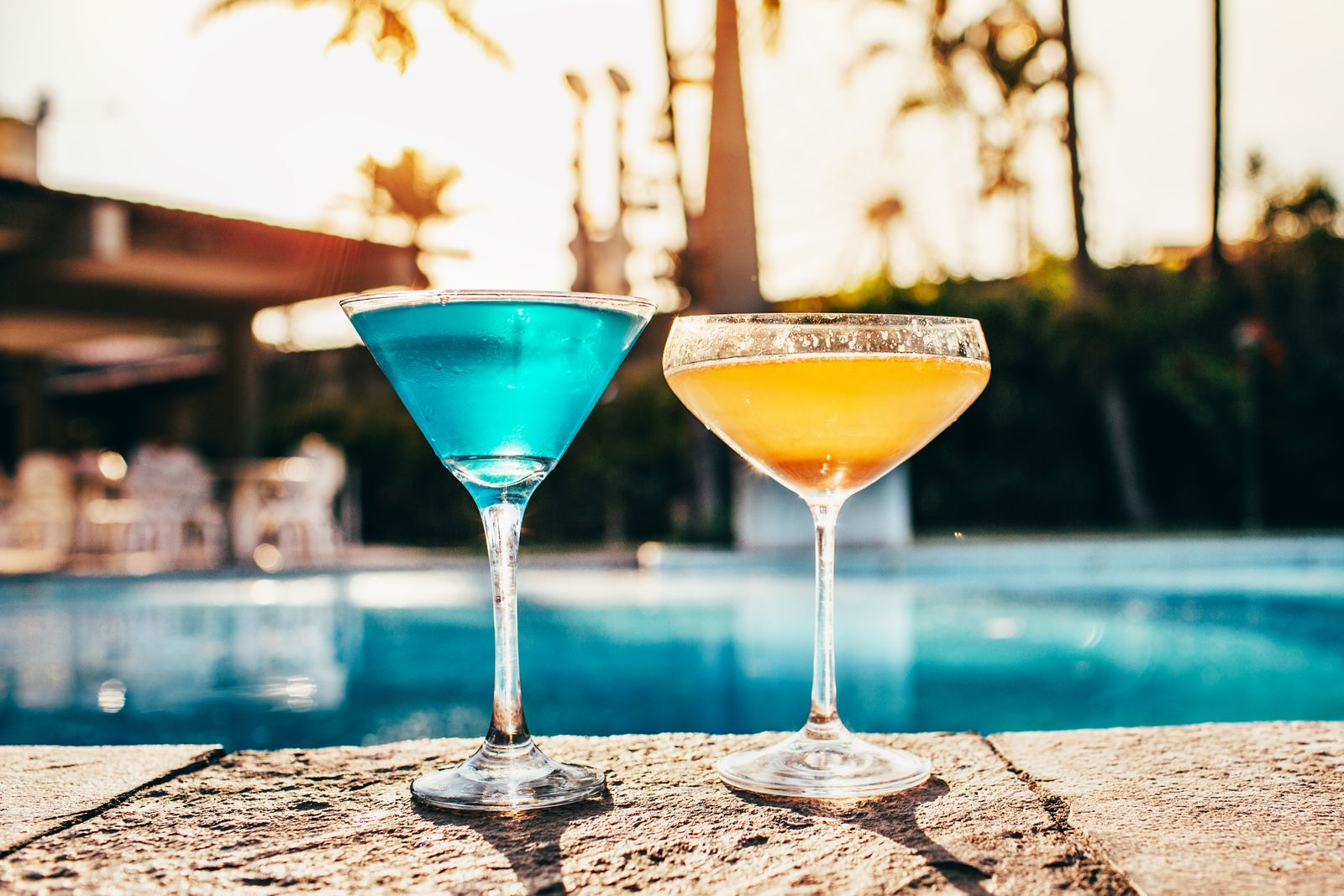 Colorful cocktails by the pool at sunset