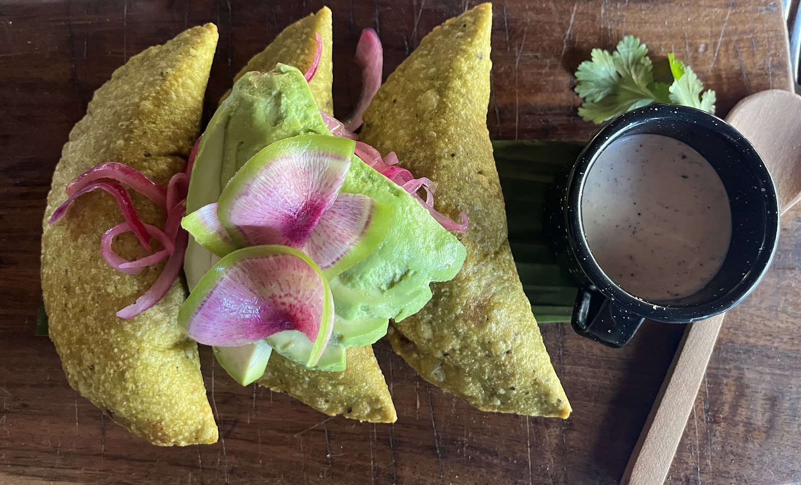Colorful tacos topped with pickled onions