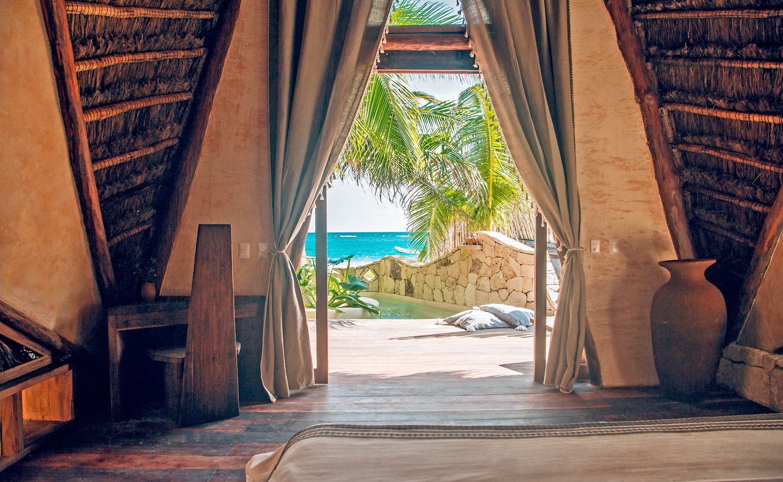 Curtained doorway opening onto the beach