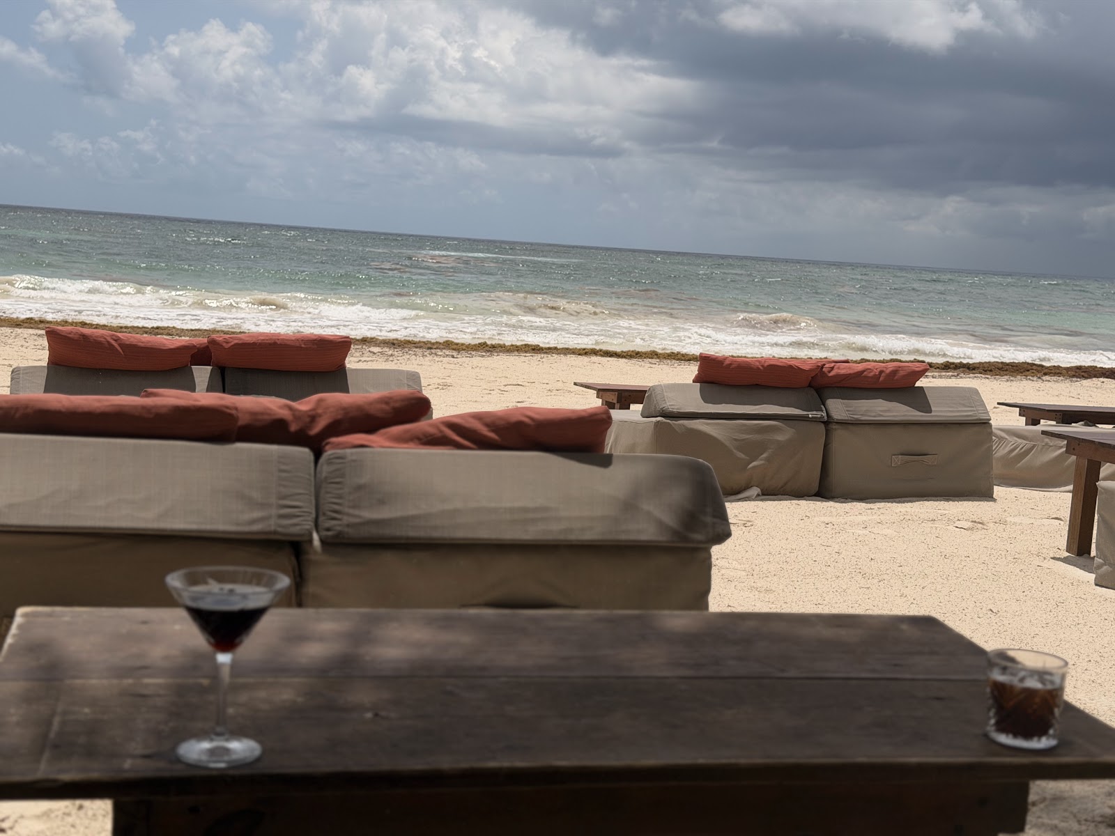 Cushioned lounge sofas facing the sea