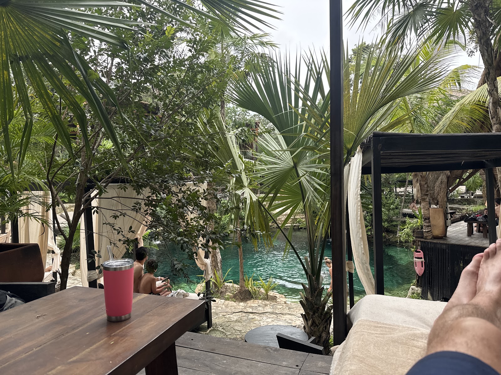 Drinks served on a table beside the cenote
