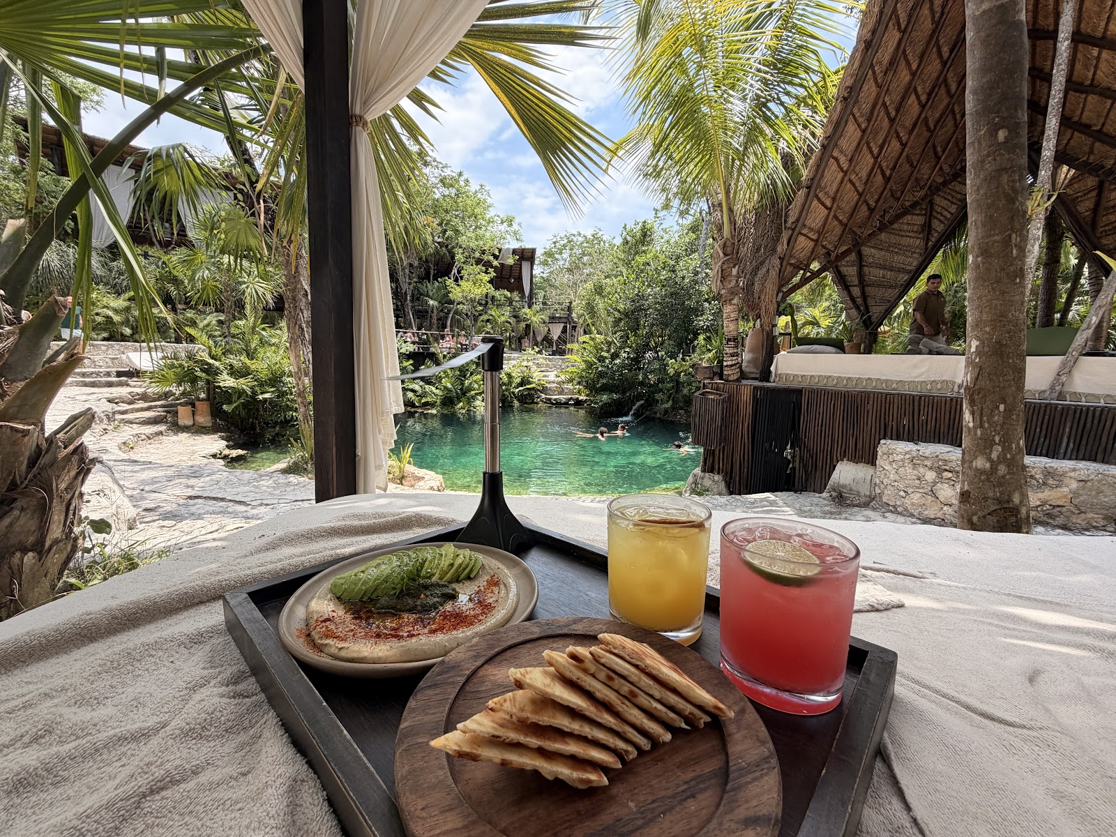 Fresh juices and a meal on a daybed table