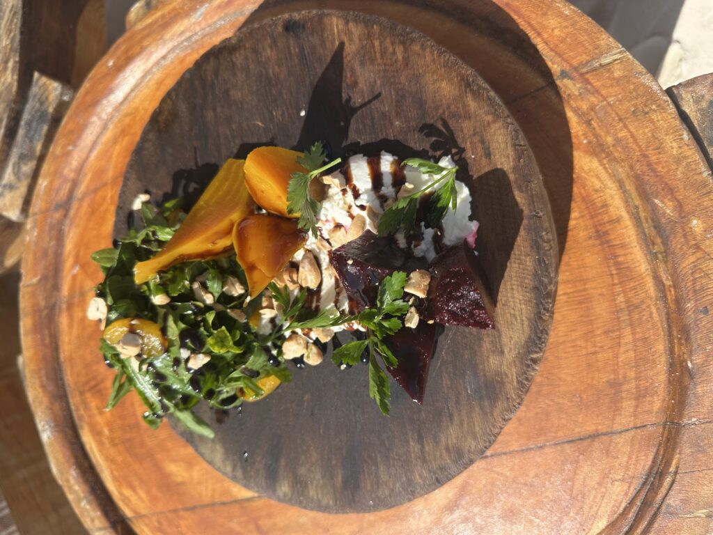 Fresh salad with mango served in a carved wooden bowl