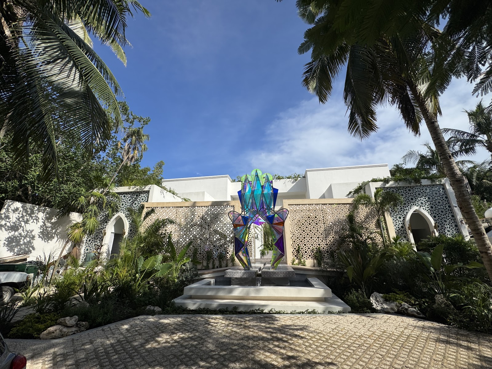 Garden entrance path lined with palm trees