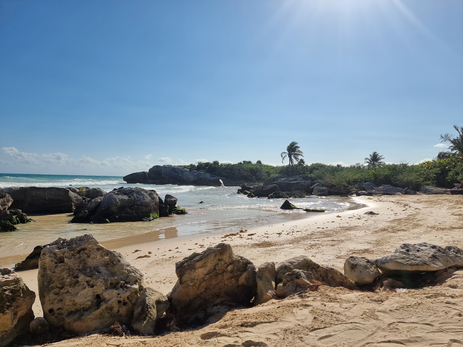 Golden sand and rocks along the Tulum coast