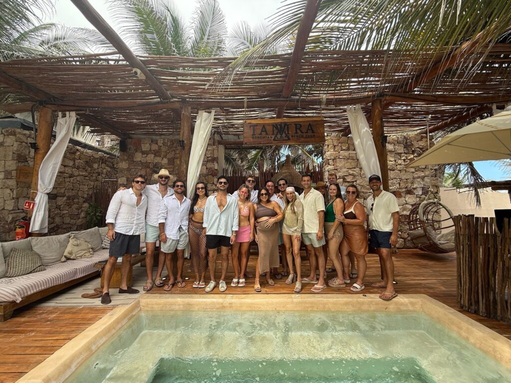 Large group celebrating together beside a small pool