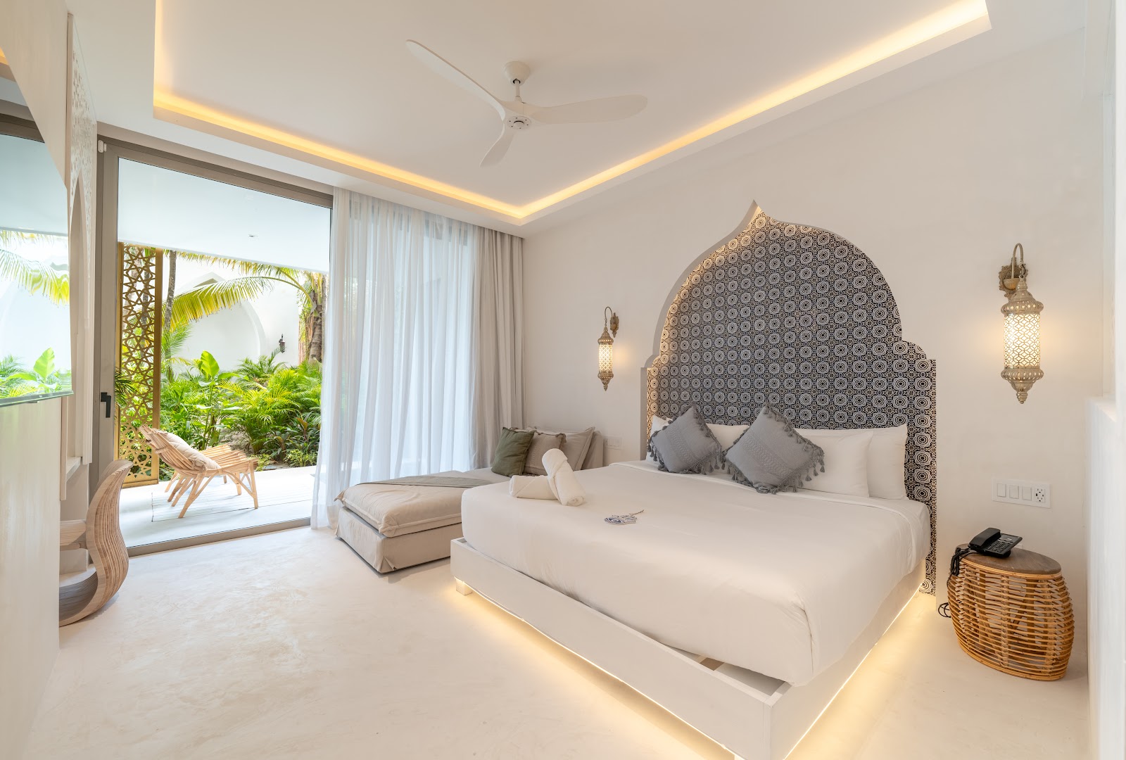 Guest room with arched headboard and private terrace