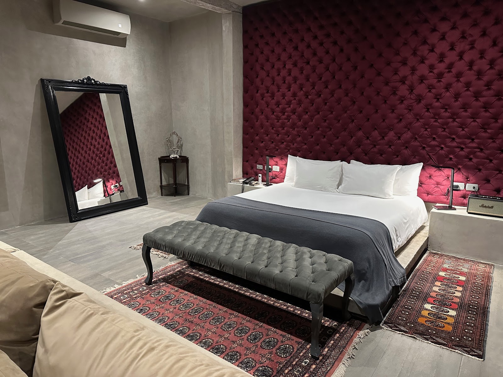 Guest room with a red velvet headboard