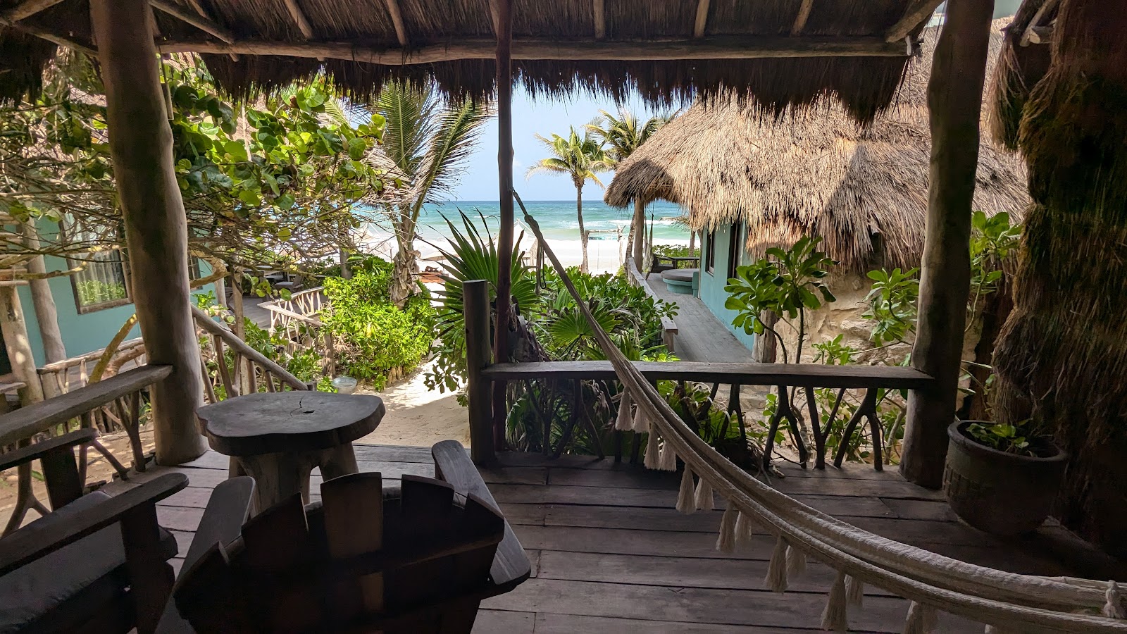 Hammock under a thatched palapa with a view of the sea
