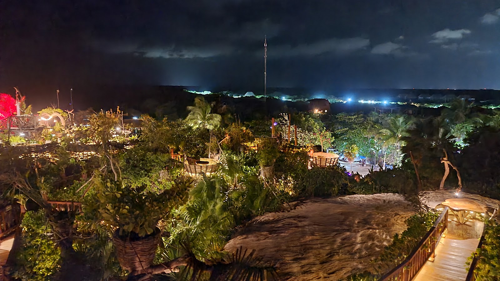 Jungle lounge lit up at night at Kanan Tulum