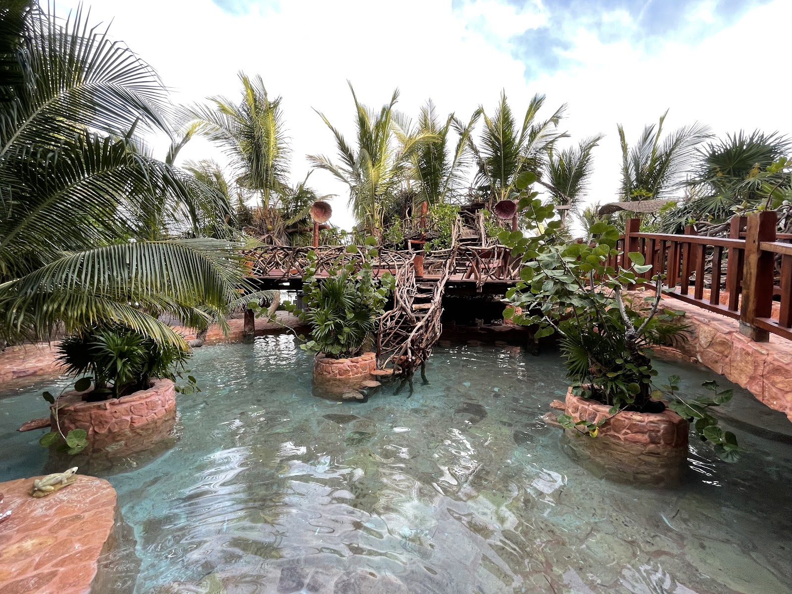 Kanan Tulum water garden with potted palms