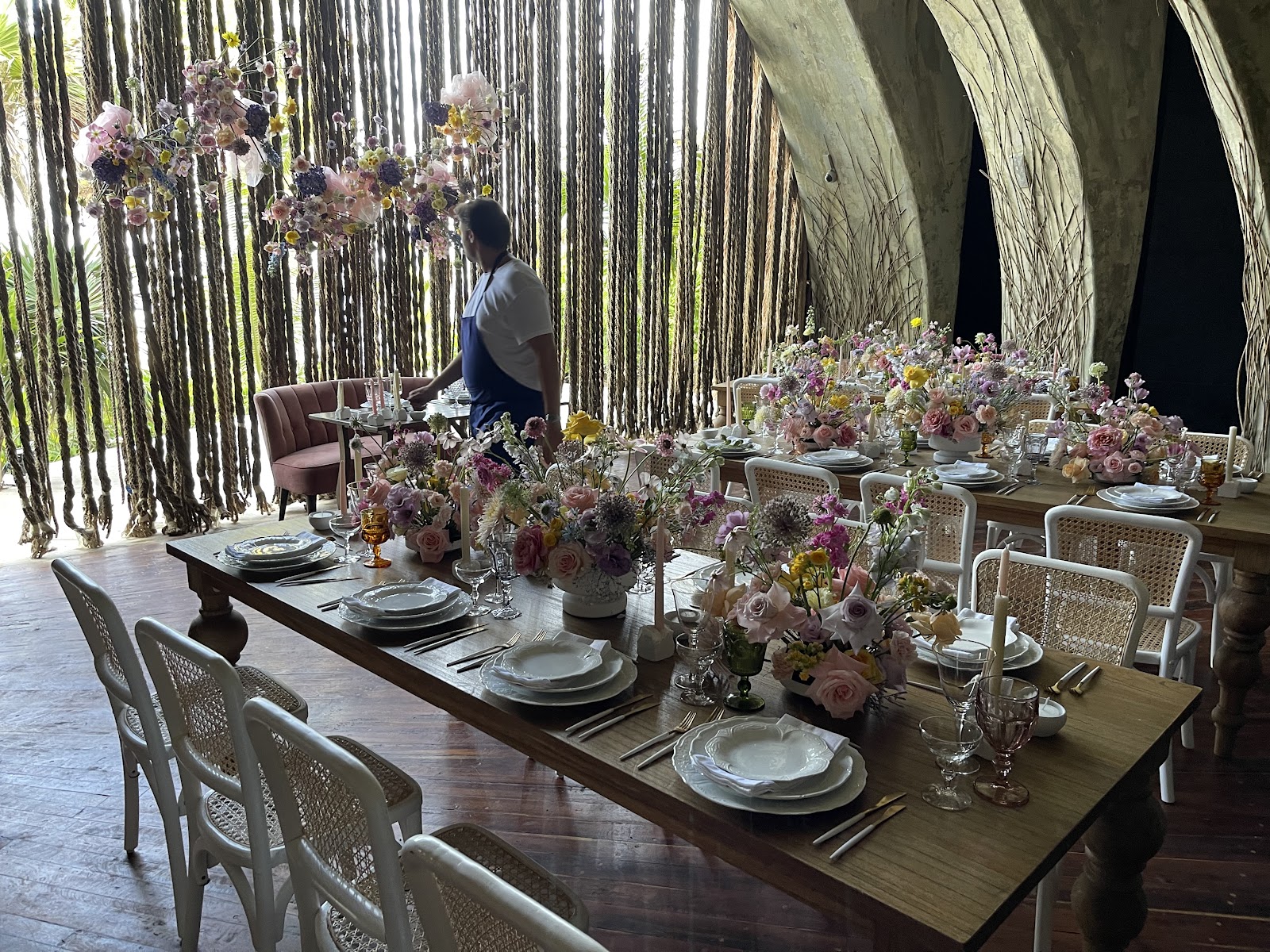 Long communal dining table decorated with flowers