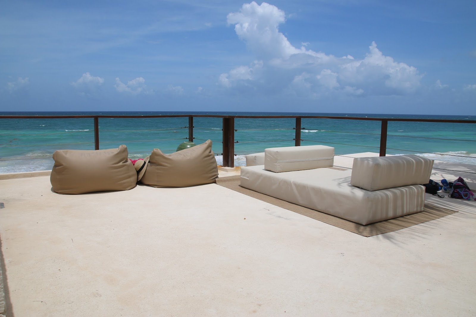 White lounge sofas and bean bags on a sea-view terrace