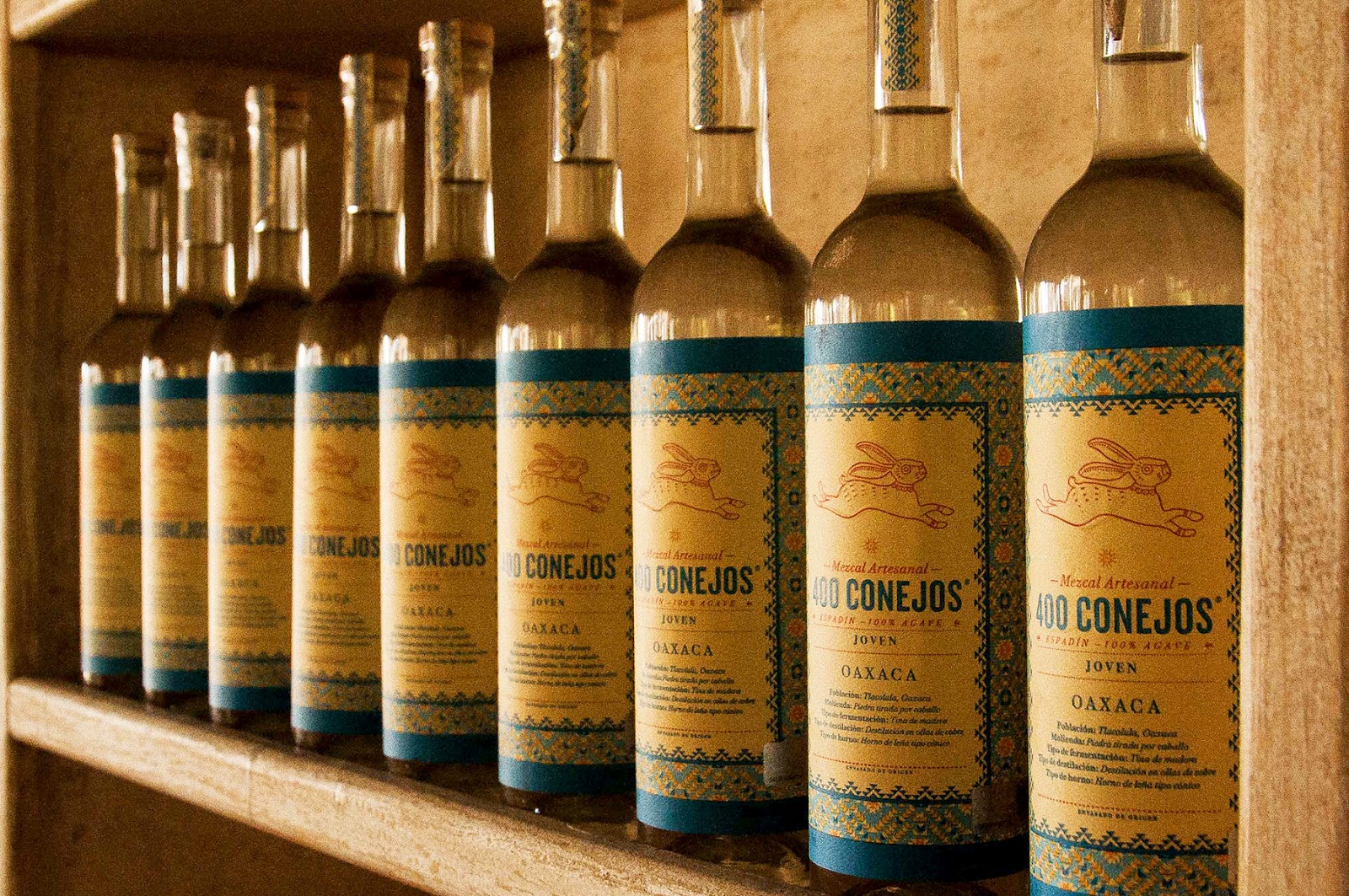 Bottles of mezcal lined up on a shelf