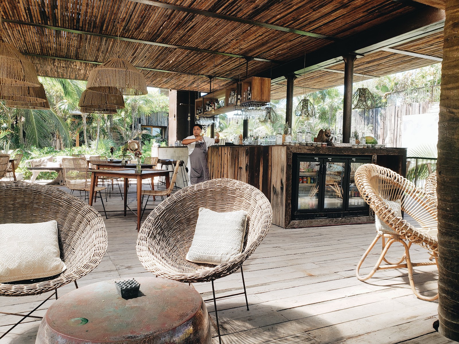 Open-air dining area with rattan chairs