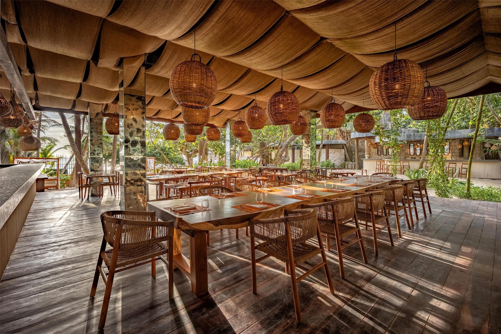 Open-air restaurant with wooden beams and tables