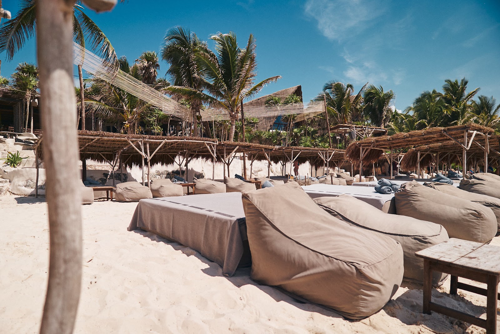 Papaya Playa Project Beach Club lounge beds and bean bags on the sand