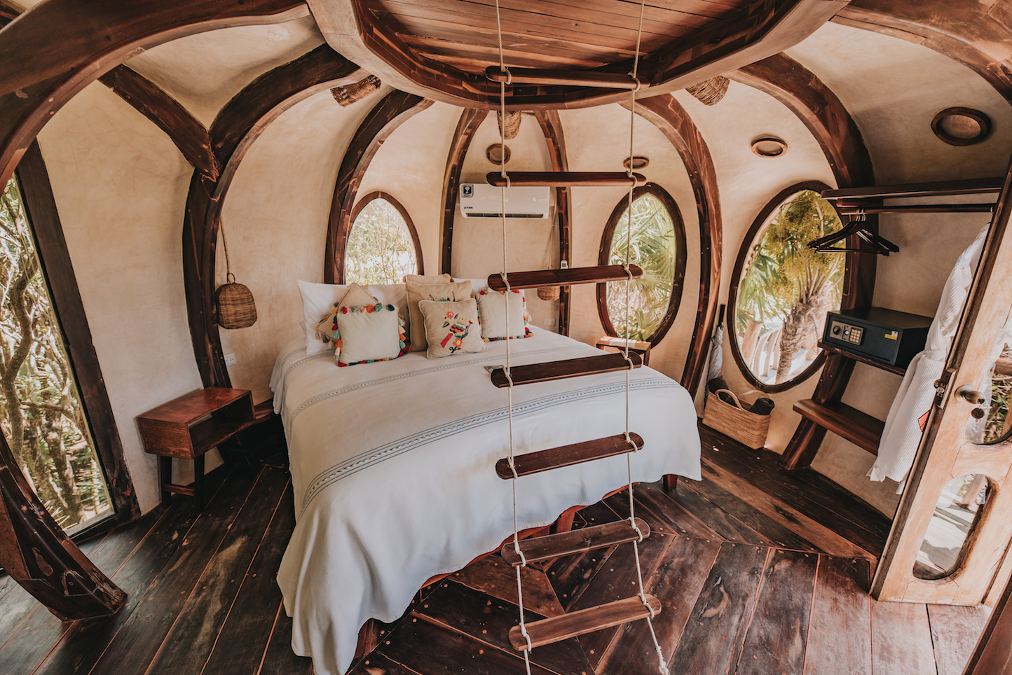 Papaya Playa Project suite with round windows and bohemian decor
