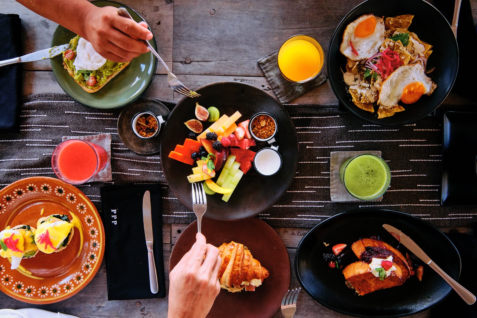 Papaya Playa Project breakfast spread with fruit, eggs and juices