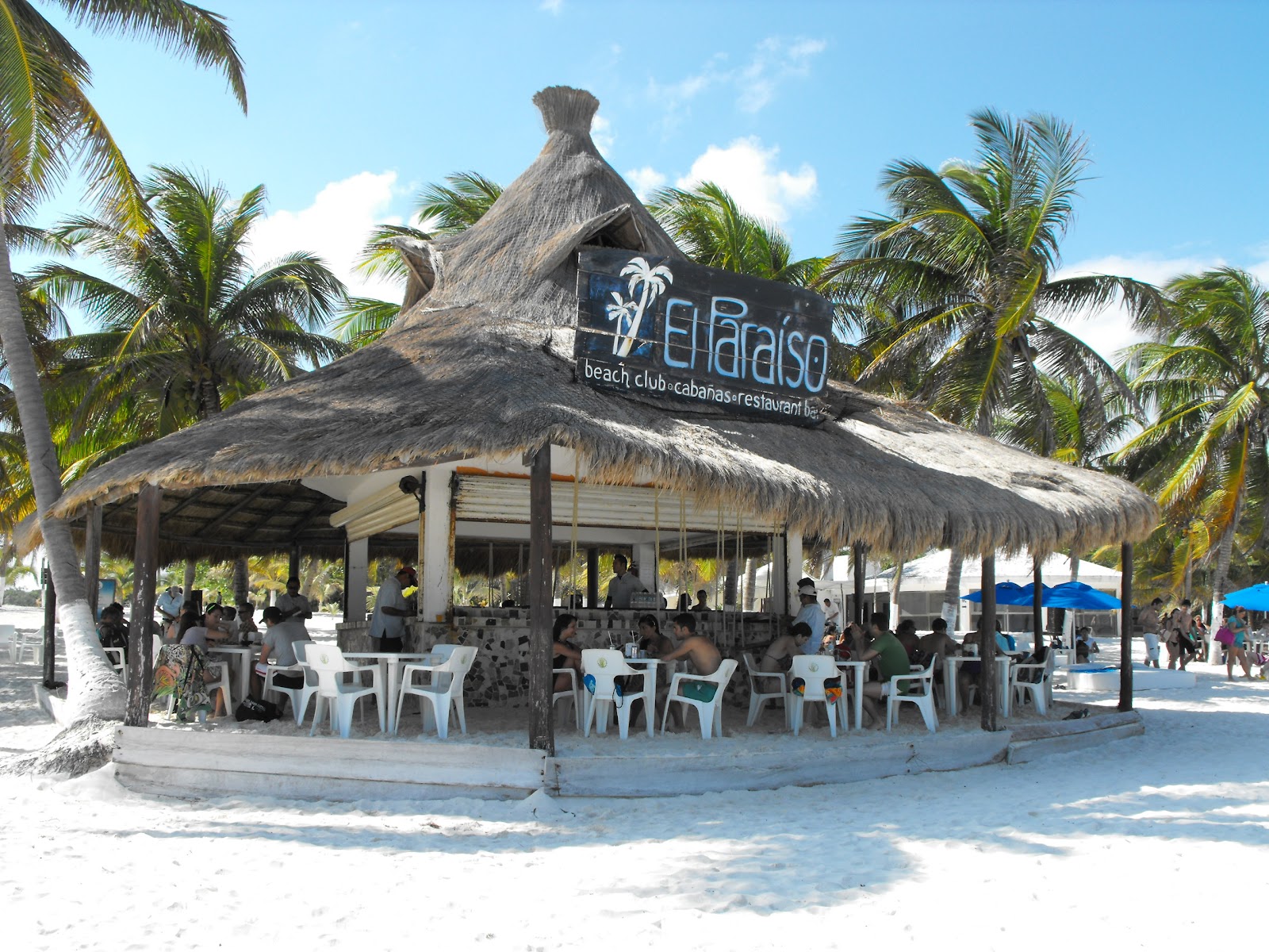 Playa Paraíso Beach Club restaurant under a thatched palapa on the sand