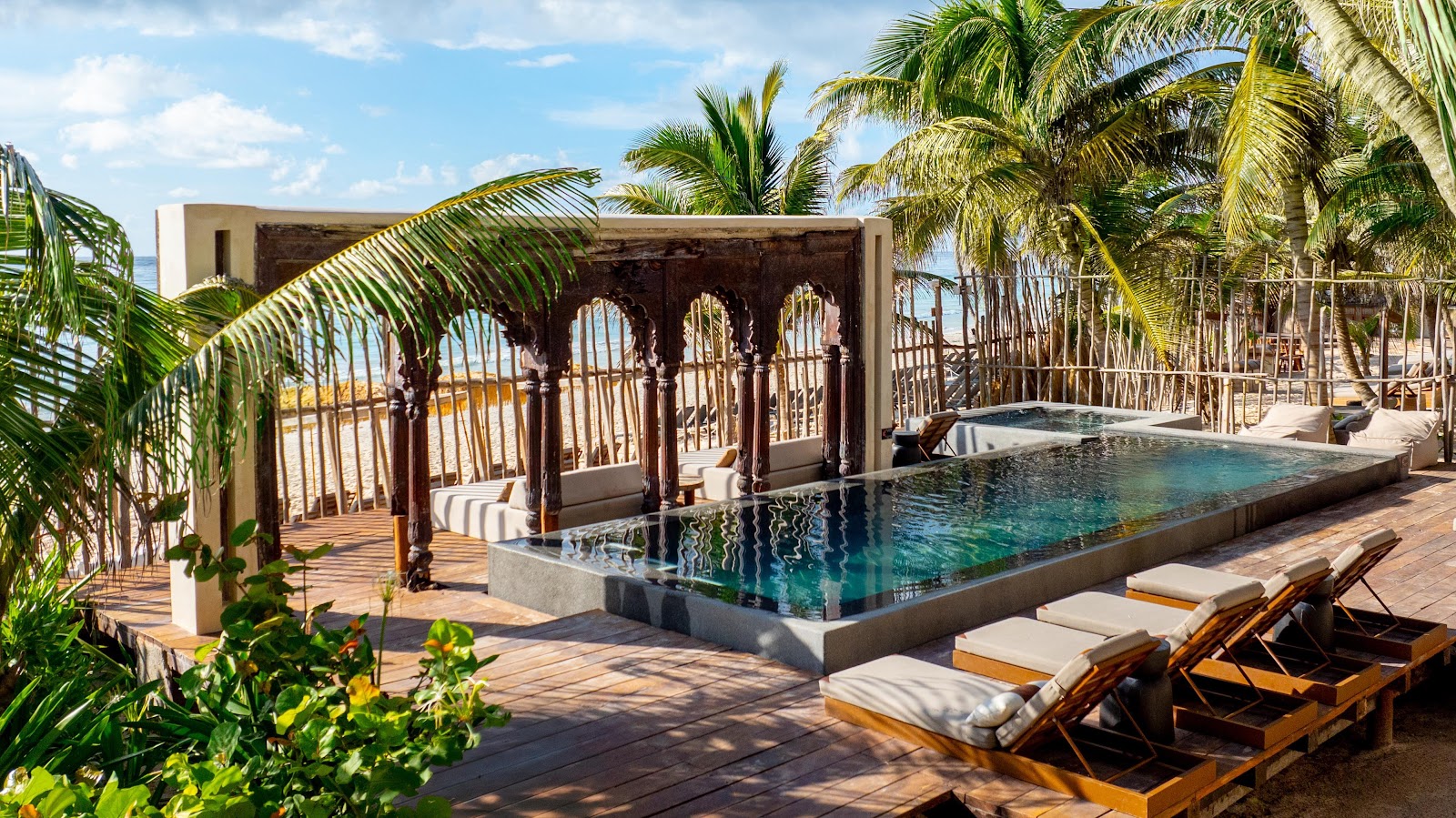 Pool with Moorish-style arches and sun loungers