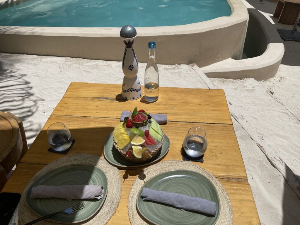 Reserved poolside table set with plates, napkins and a starter