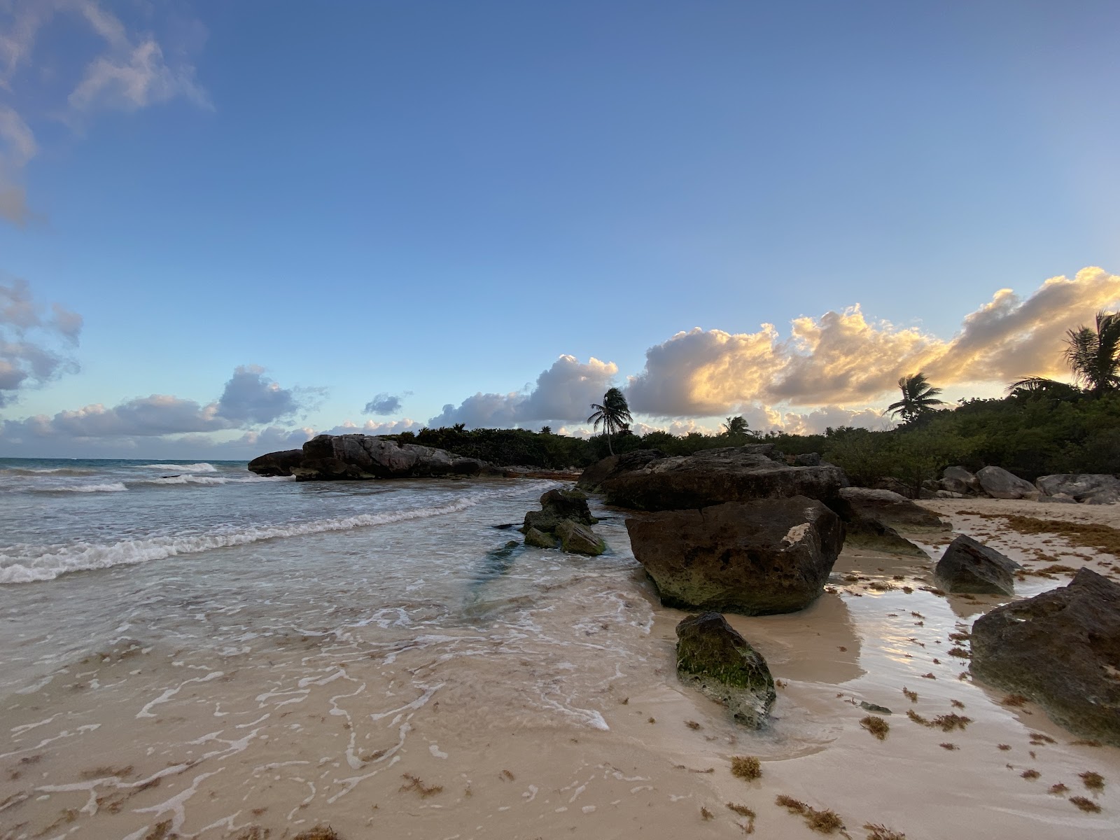 Rocky shoreline at sunset in Tulum