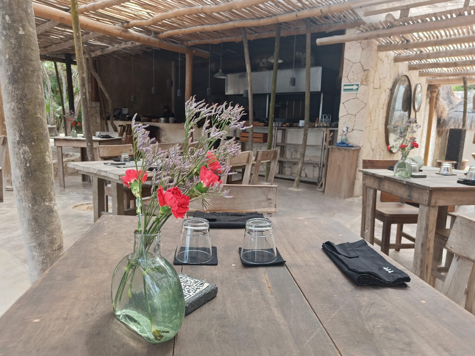 Rustic restaurant tables set with fresh flowers