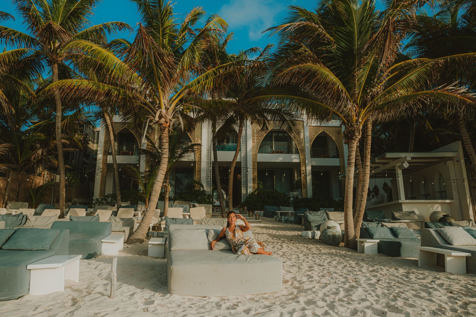 Sana Tulum beach club lounge shaded by palm trees