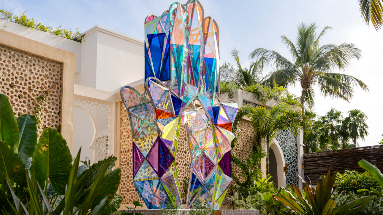 Sana Tulum stained glass hamsa sculpture in the garden