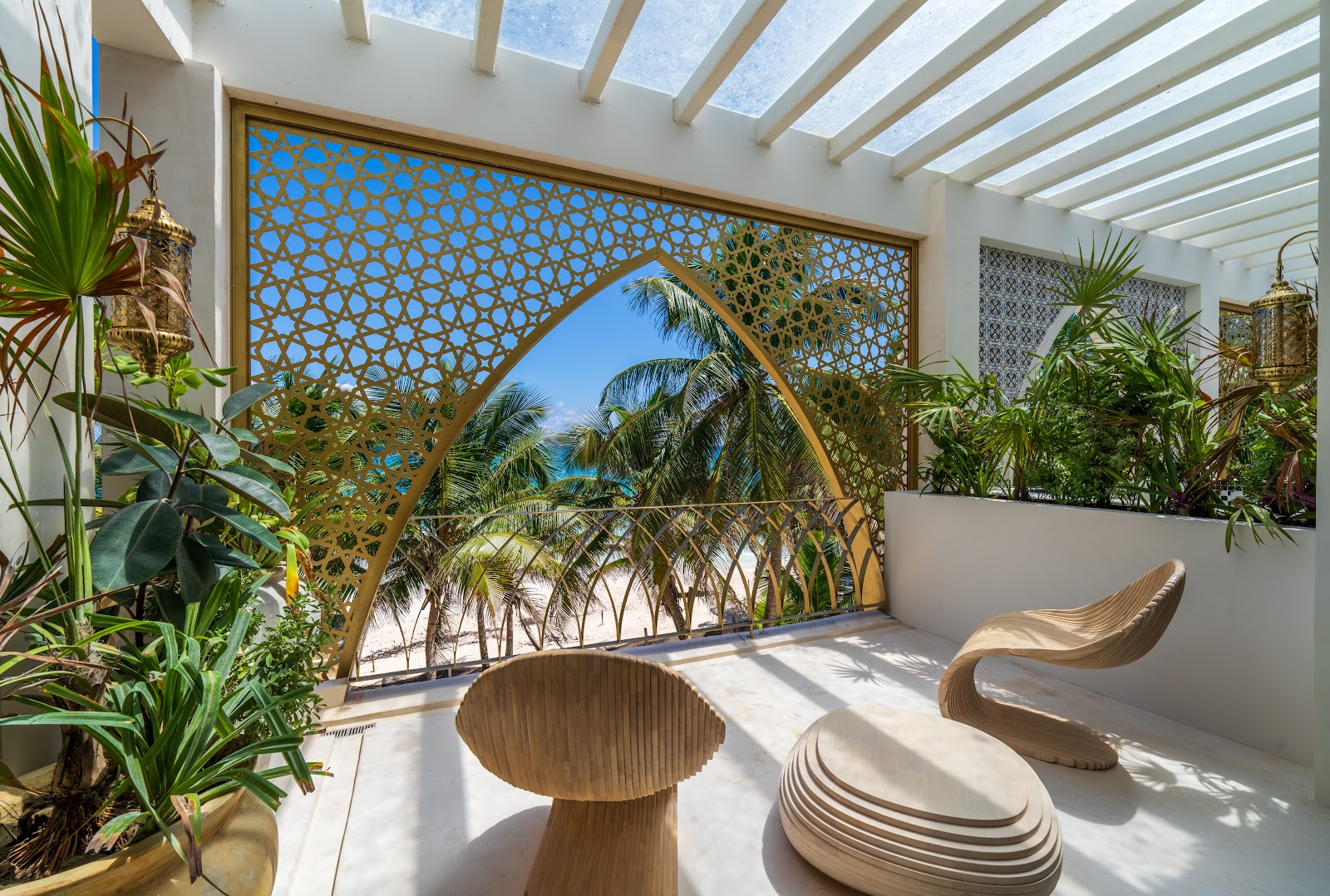 Sana Tulum lounge with a Moroccan lattice arch framing the palms