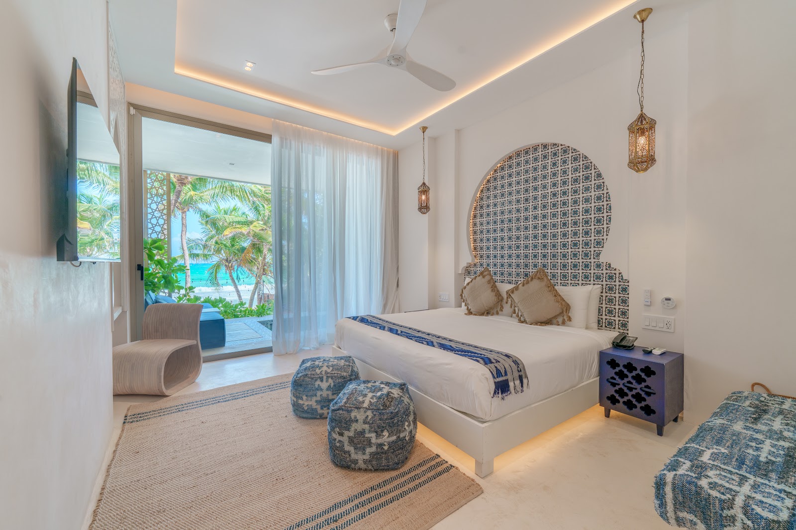 Sana Tulum suite with a tiled headboard and garden view