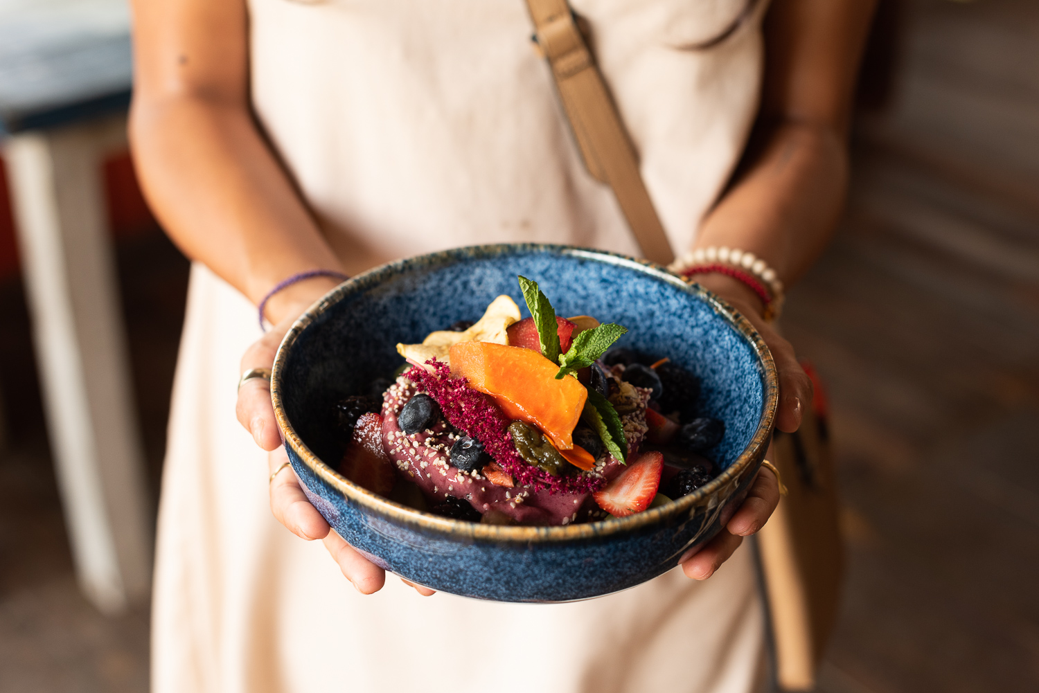 Server holding a bowl of food