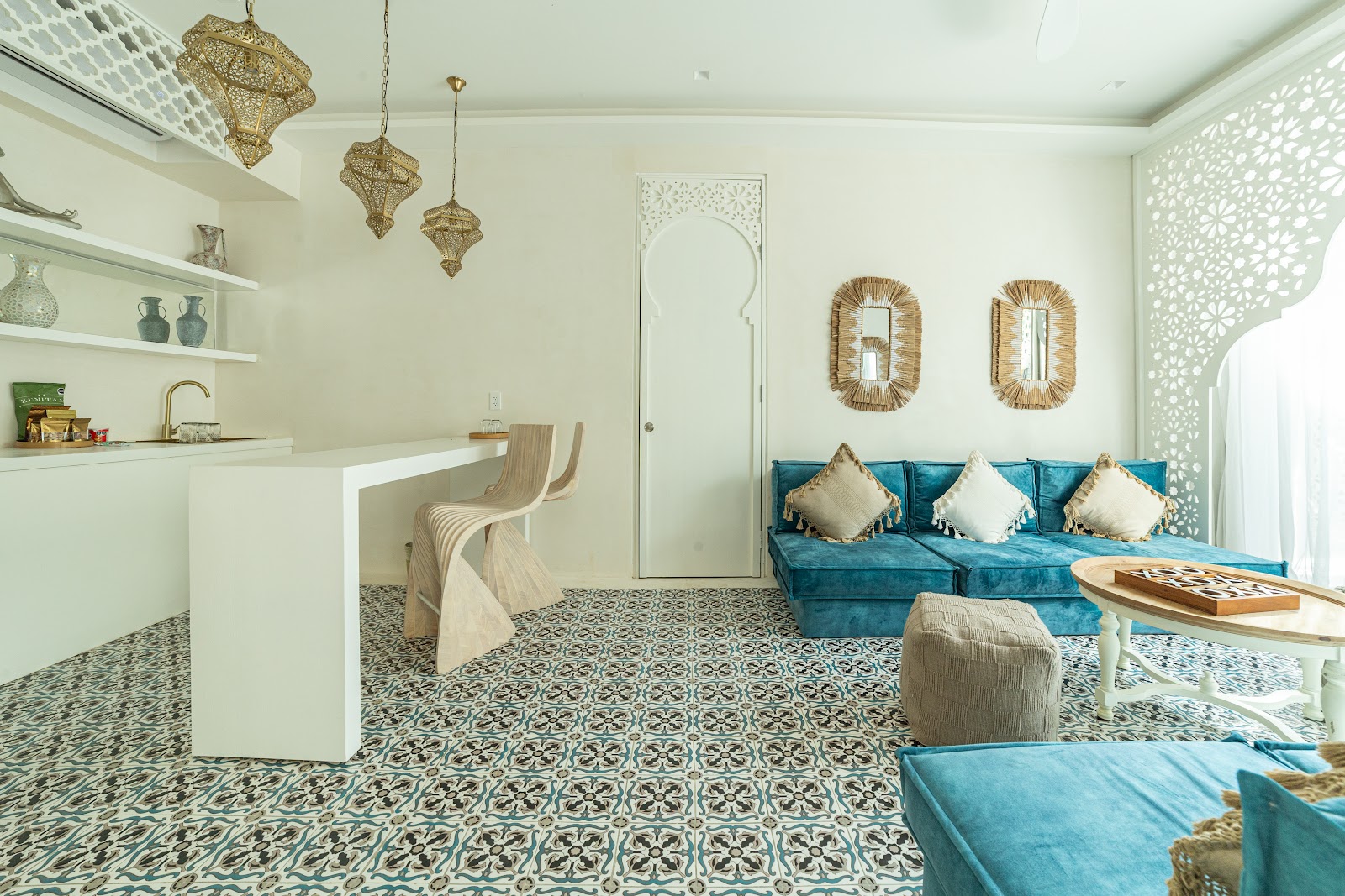 Suite living area with blue cushions and Moroccan tiles