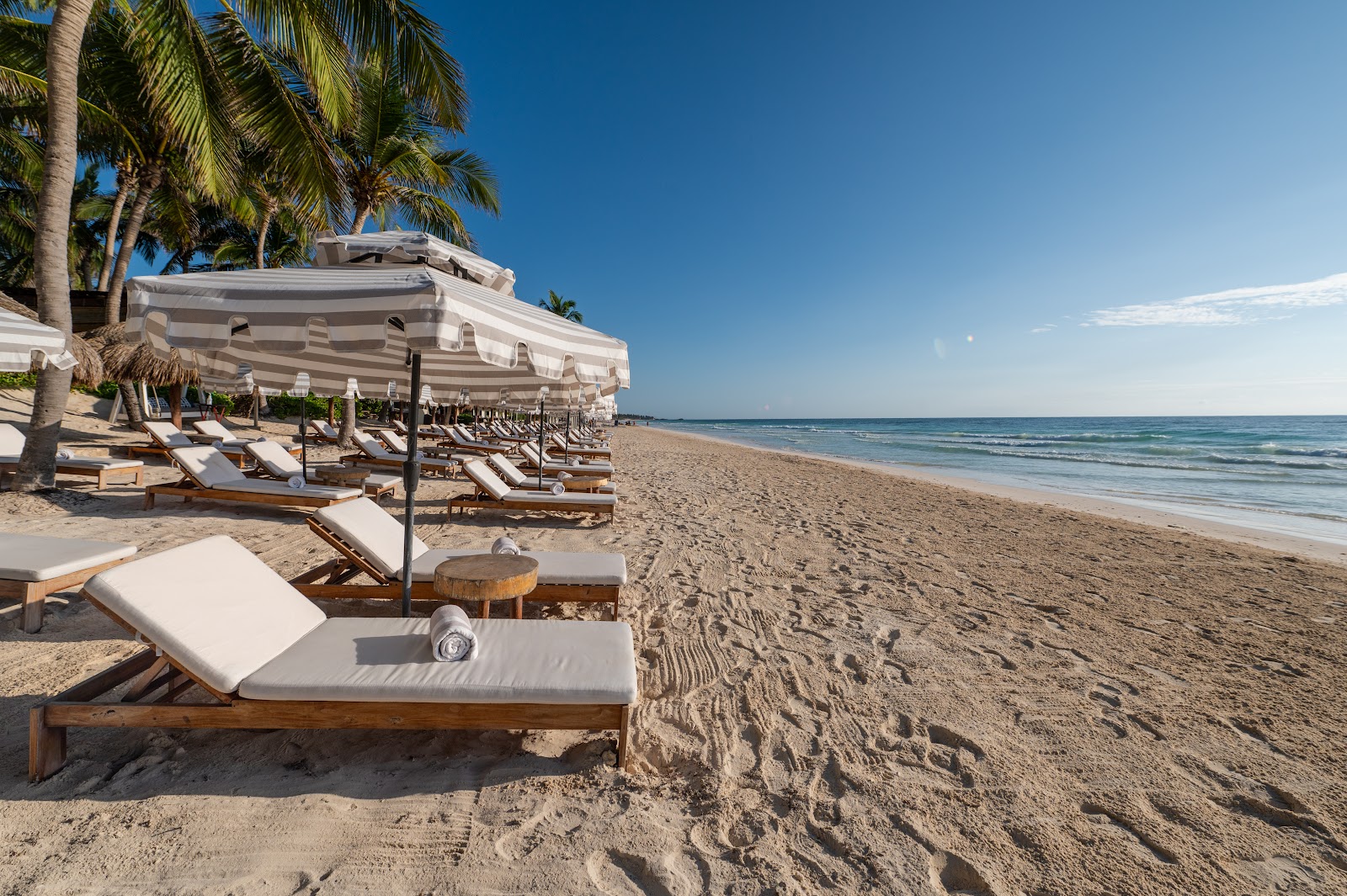 Sun loungers and umbrellas on the white sand beach